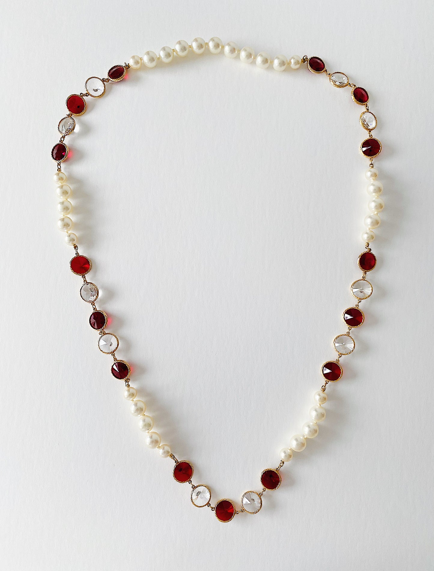 Long strand vintage necklace with red and clear Rivoli crystals and knotted pearls