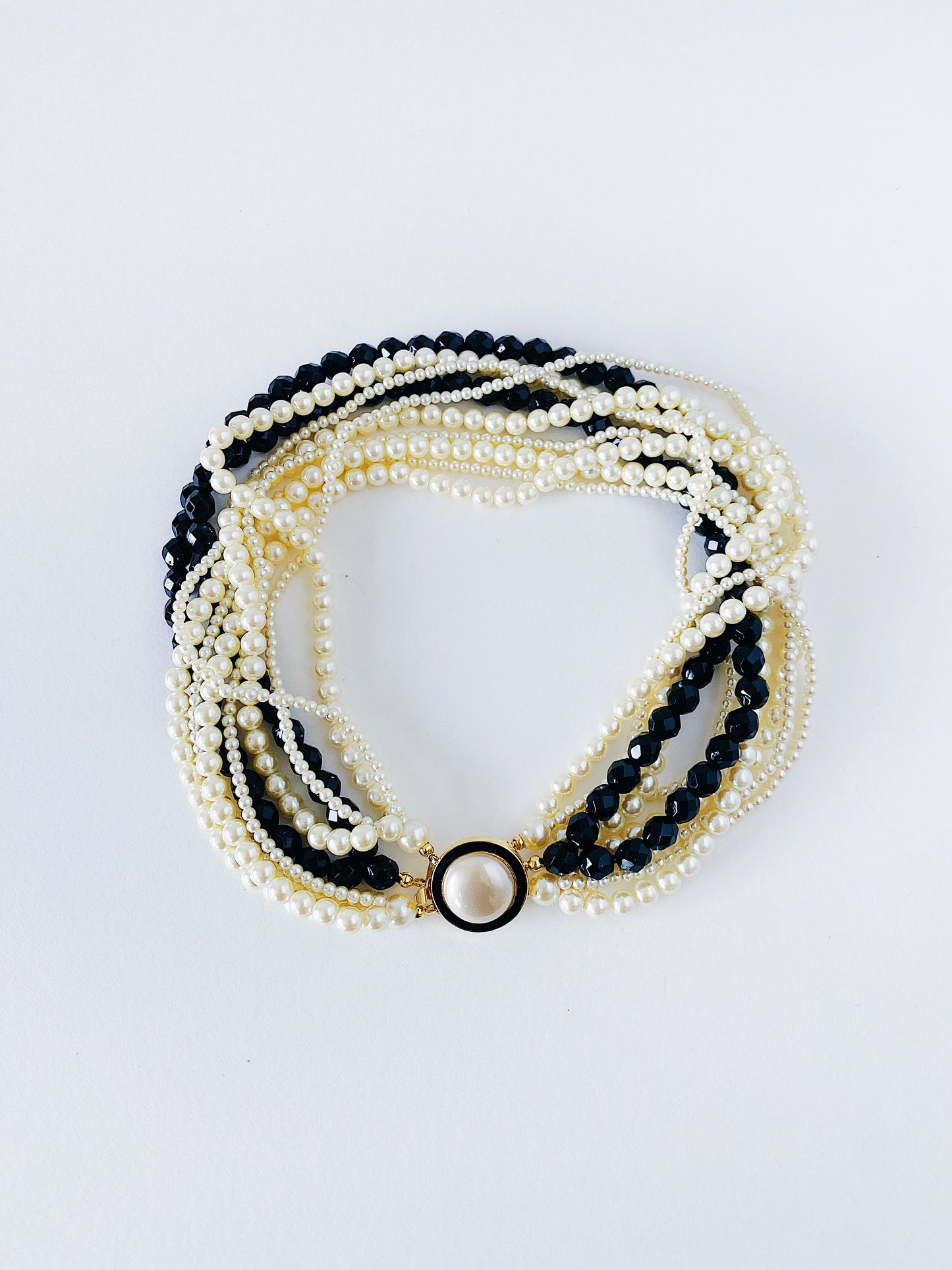 Vintage 1980s Carolee 10-strand faux pearl necklace, black bead accents, gold-plated enamel clasp, 17 inches, heavy weight statement jewelry