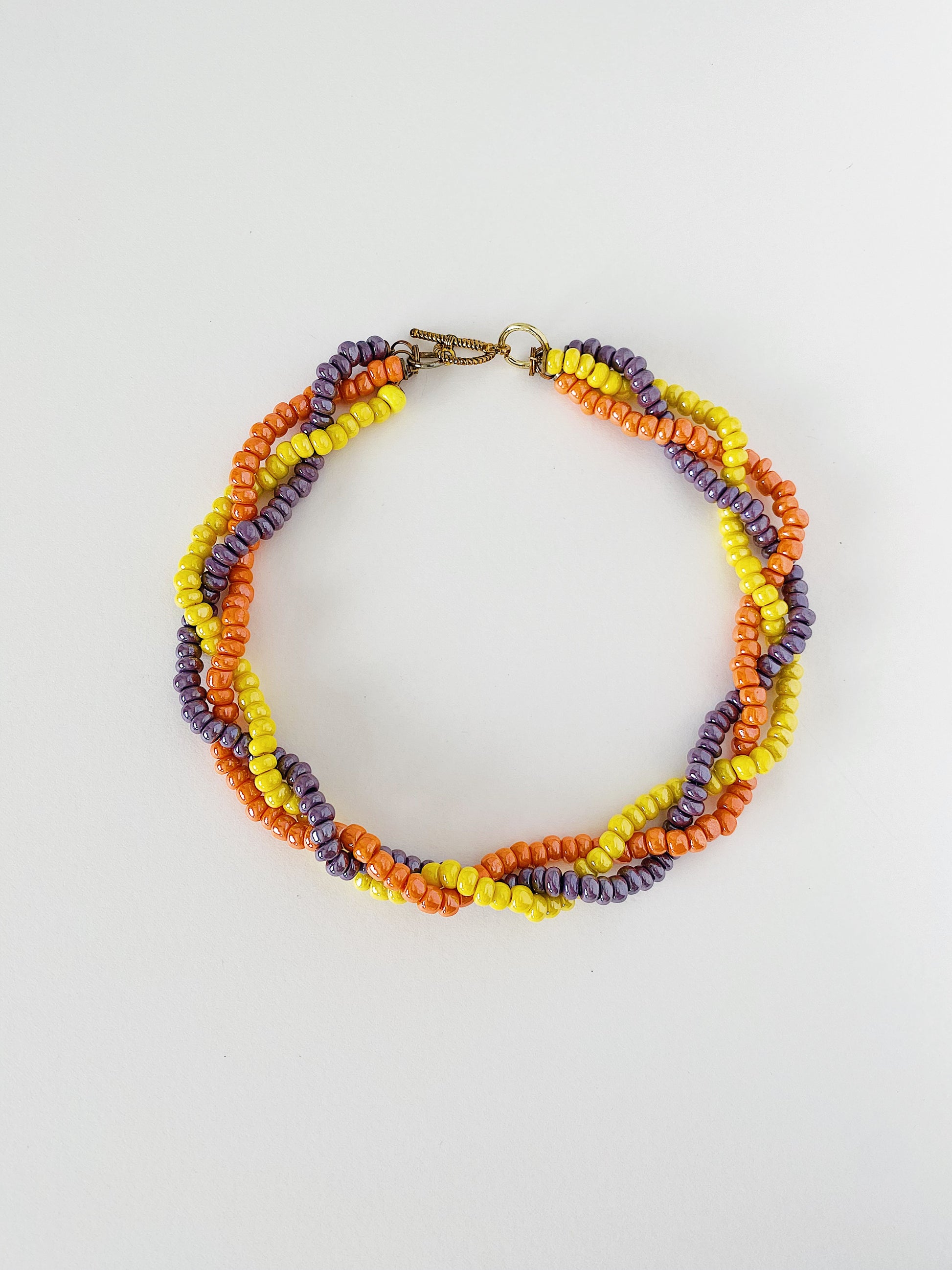Vintage 1950s braided glass bead necklace in orange, yellow, and purple, mid-century multicolor statement necklace