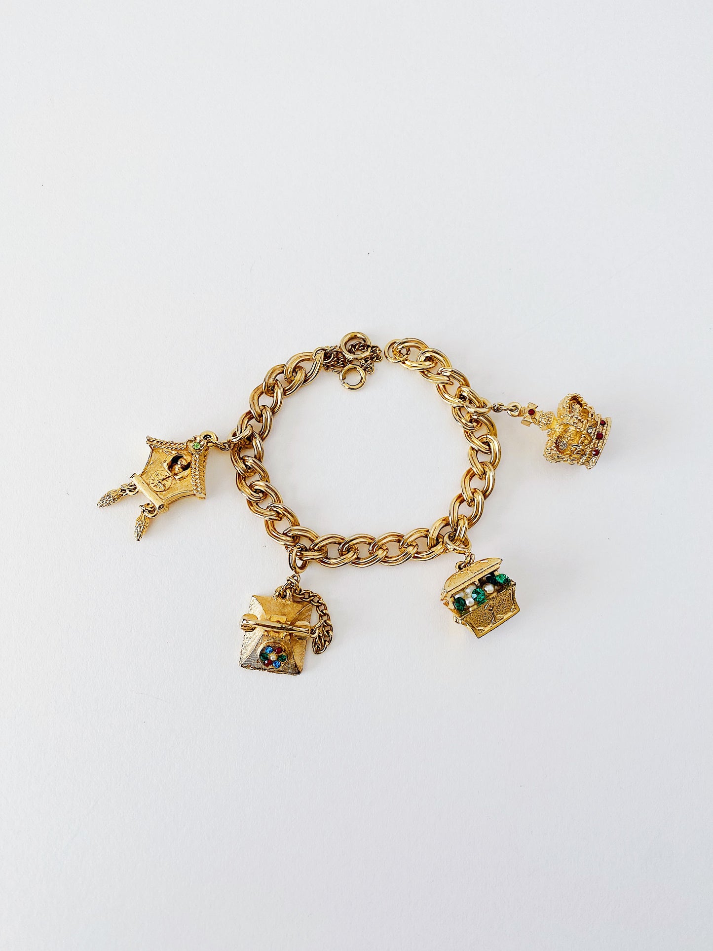 Vintage 1950s charm bracelet with gold-plated cuckoo clock, telephone, treasure chest, crown charms, faux pearls, rhinestones, 7 inch collectible bracelet