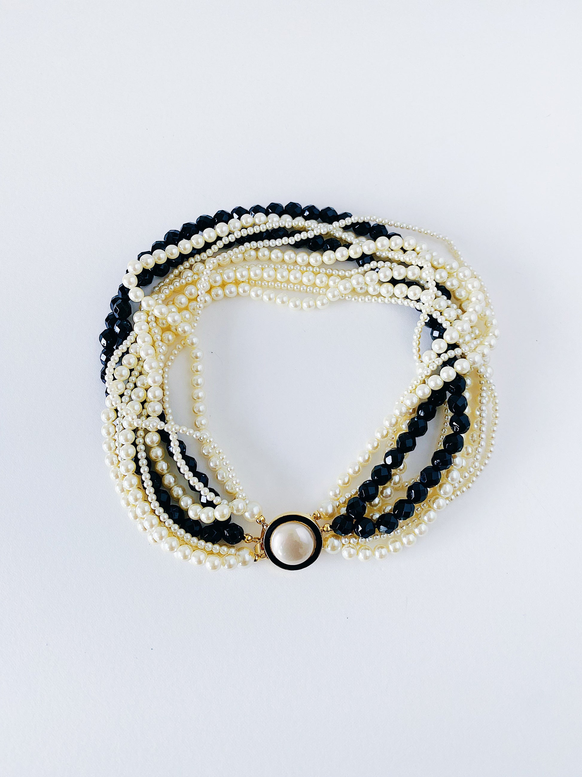 Vintage 1980s Carolee 10-strand faux pearl necklace, black bead accents, gold-plated enamel clasp, 17 inches, heavy weight statement jewelry
