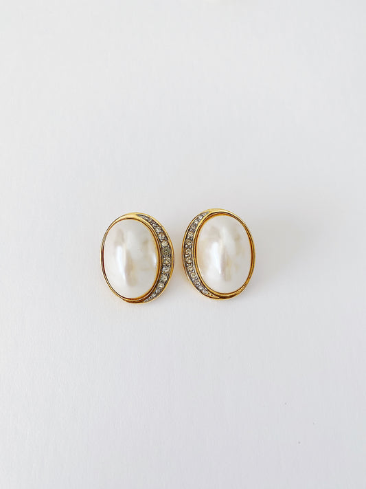 Vintage 1980s Richelieu clip-on earrings with faux pearl center, gold-plated oval design, crescent pavé rhinestone accents, lightweight classic earrings