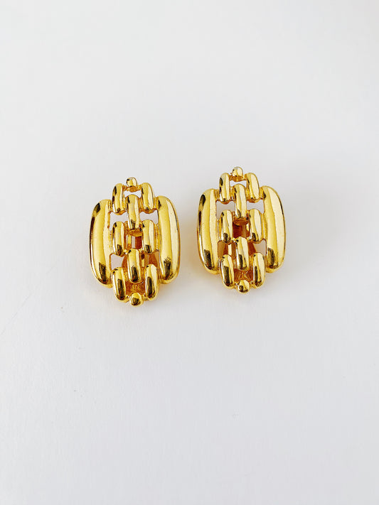 Vintage 1980s gold link clip-on earrings, bold sculptural statement jewelry, mid-weight earrings with gold-plated finish.