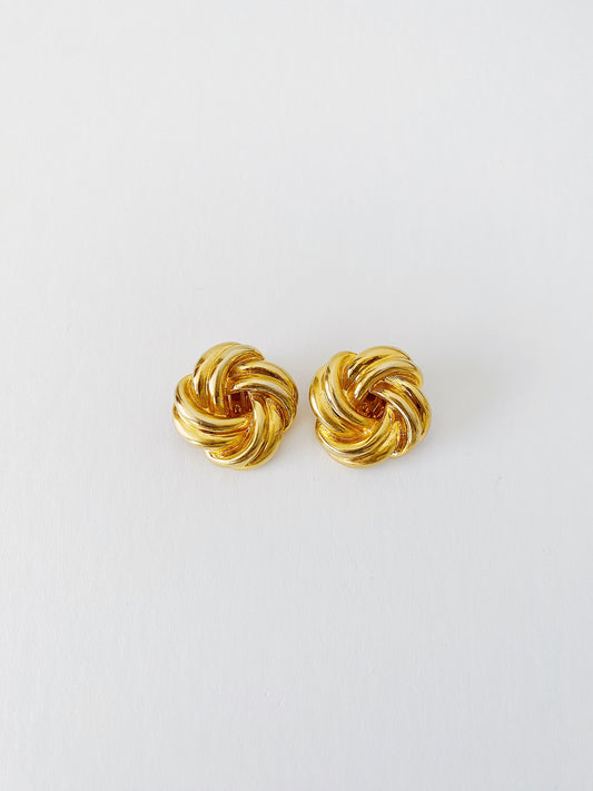 Vintage 1980s gold plated knot clip-on earrings, bold statement size, sculptural retro style, mid-weight.