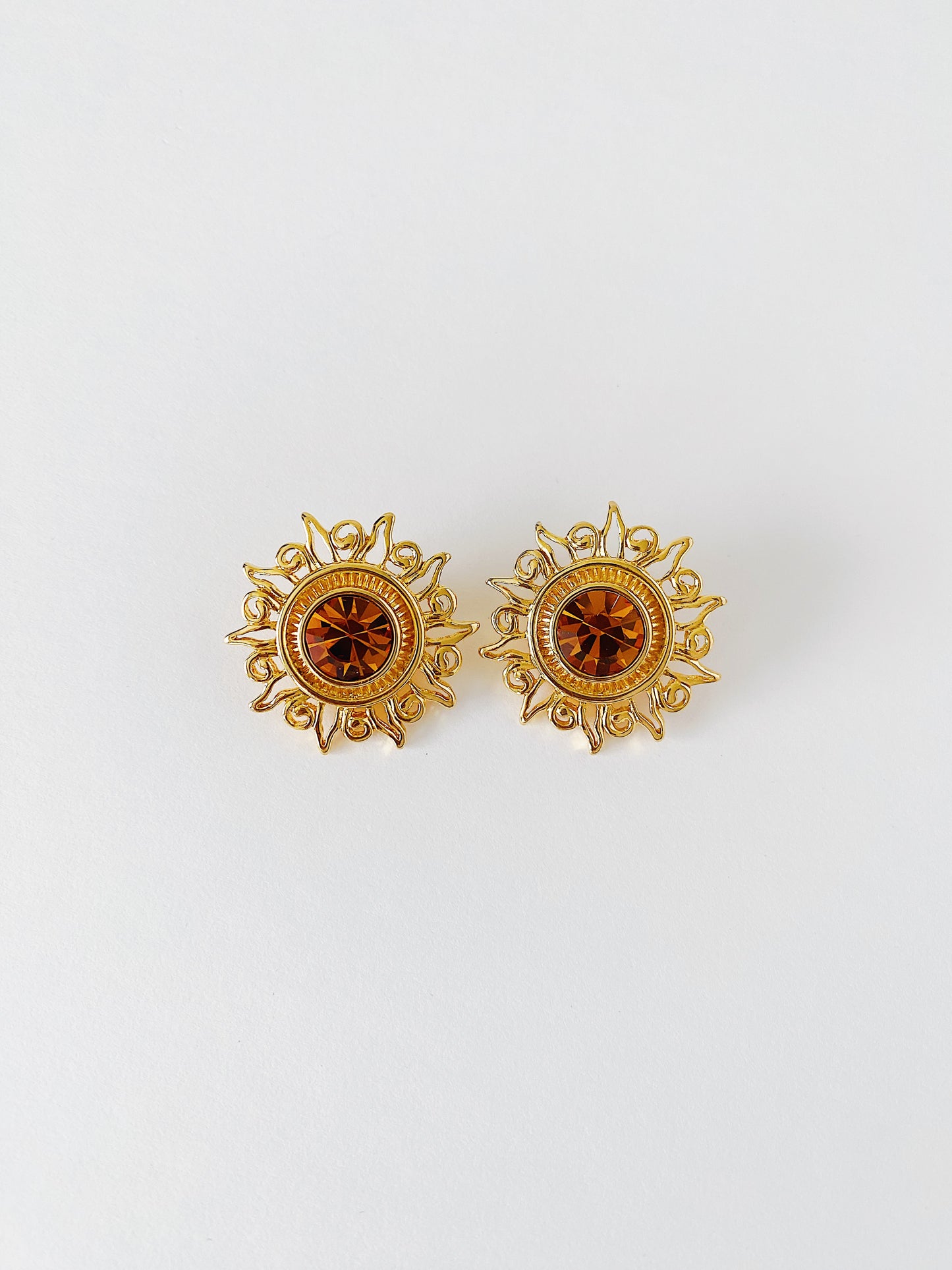 Vintage 1990s KJL Kenneth Jay Lane sunburst clip-on earrings with amber rhinestones