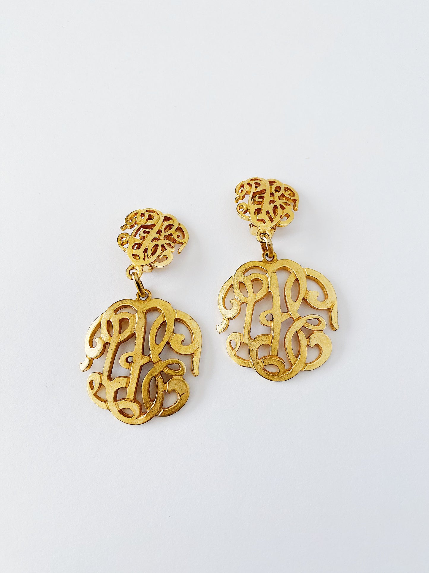 Vintage 1970s 1980s monogram-style clip-on earrings, brushed gold-plated, made in Italy, lightweight statement earrings.