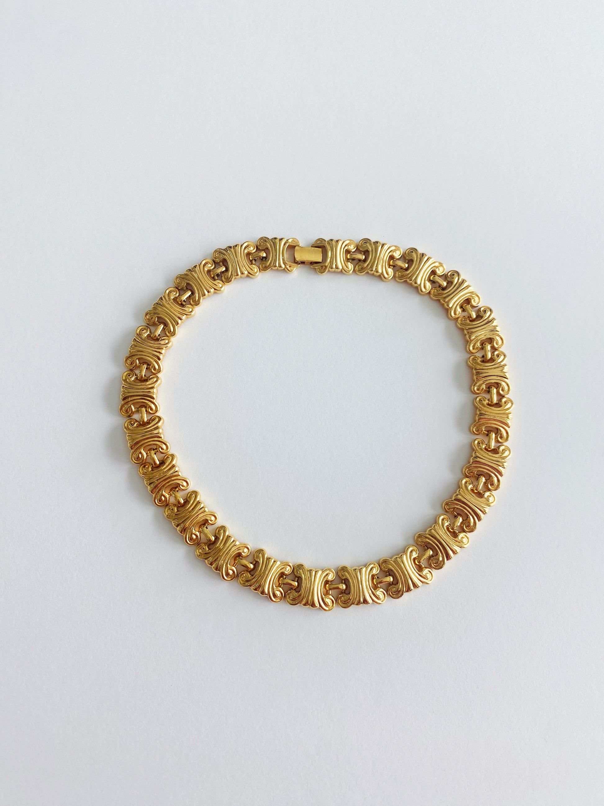 Vintage 1980s gold-plated double C arc motif chain necklace with fold-over clasp, heavy-weight statement jewelry.